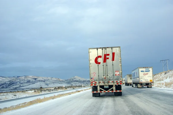 Heavy trucks speeding on icy freeway