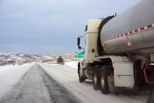 Heavy trucks speeding on icy freeway