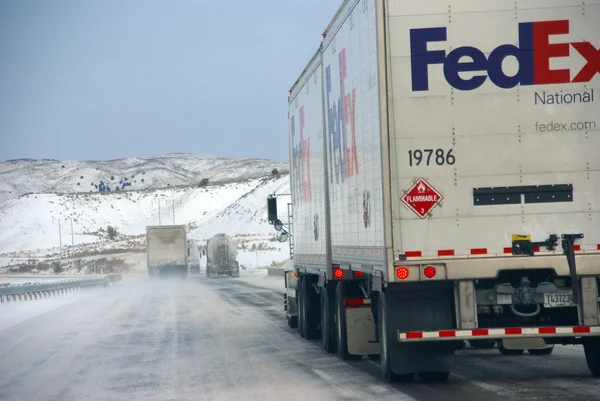 Heavy trucks speeding on icy freeway