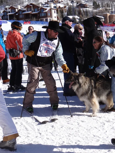 Cowboy skier and a friendly dog