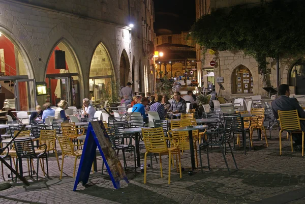 Evening diners relax in an outdoor restaurant