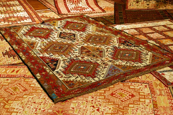 Overlapping carpets with intricate Kurdish  patterns
