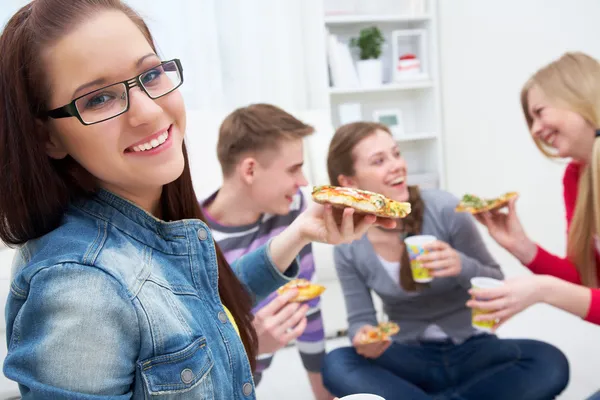 Teens party with pizza