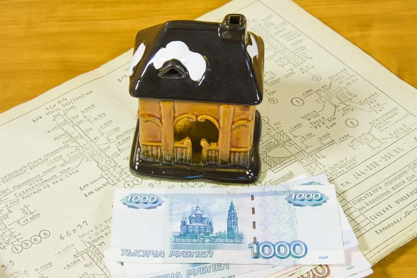 Toy house and Russian money on project documentation