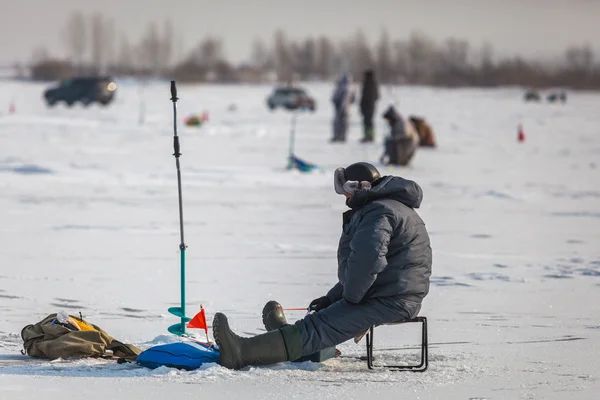 Ice Fishing on winter snow lake