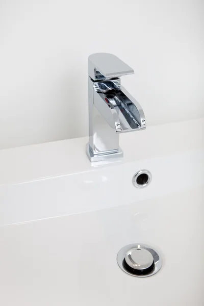 Modern faucet and plug in a hand basin