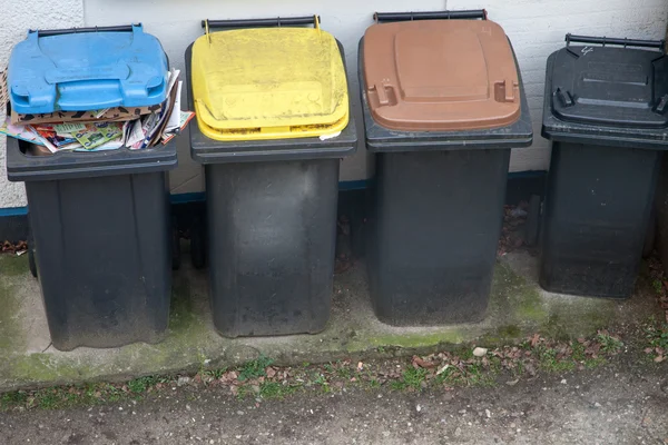 Four garbage bins colour coded for recycling