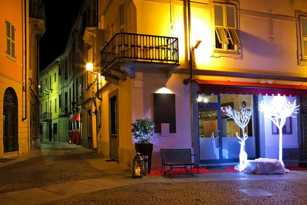 Small restaurant on the corner at night in Italy.