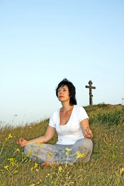 Woman concerns with yoga on sundown of the day.6.