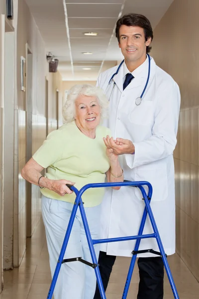Doctor Helping An Old Woman With Her Walker
