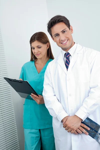 Doctor And Dental Nurse With Reports