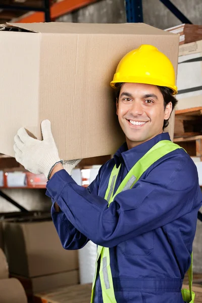 Young Foreman Lifting Cardboard Box