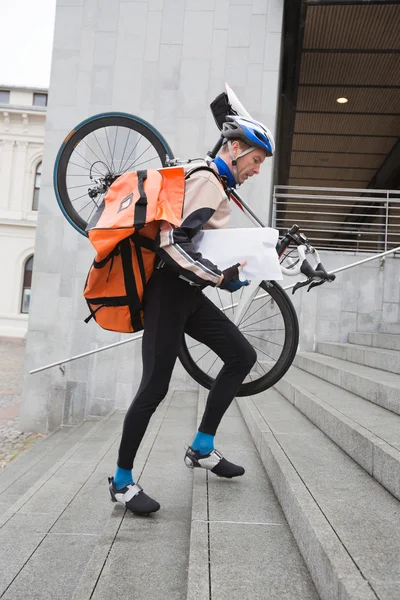 Courier Delivery Man With Bicycle And Backpack Walking Up Stairs