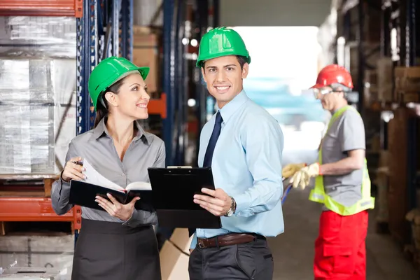 Supervisors And Foreman Working At Warehouse