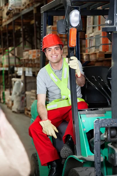Foreman Sitting In Forklift At Warehouse