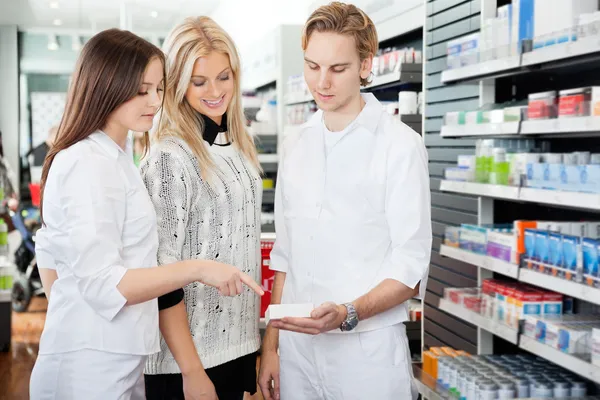 Pharmacist Assisting Female Shopper