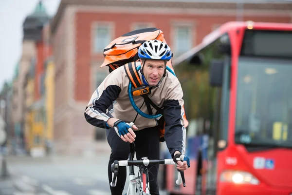 Male Cyclist With Courier Delivery Bag Riding Bicycle