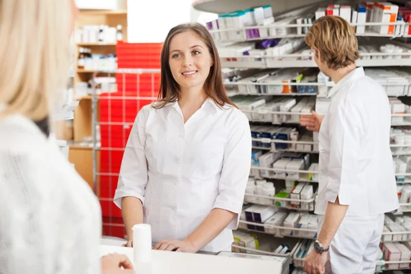 Female Pharmacist Helping Customer
