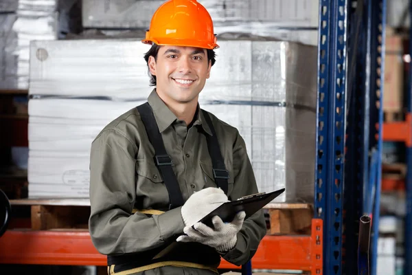 Young Male Supervisor With Clipboard Smiling