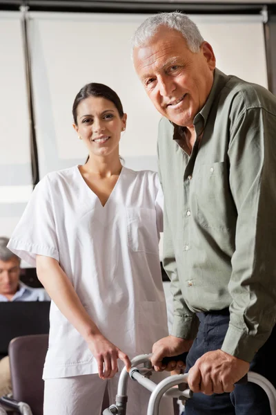 Nurse Helping Male Patient With Walker