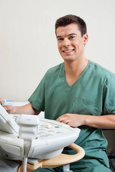 Male Technician Operating Ultrasound Machine