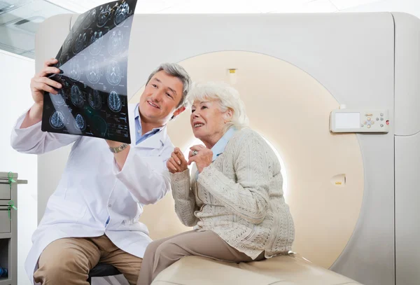 Doctor And Patient Looking At CT Scan X-ray