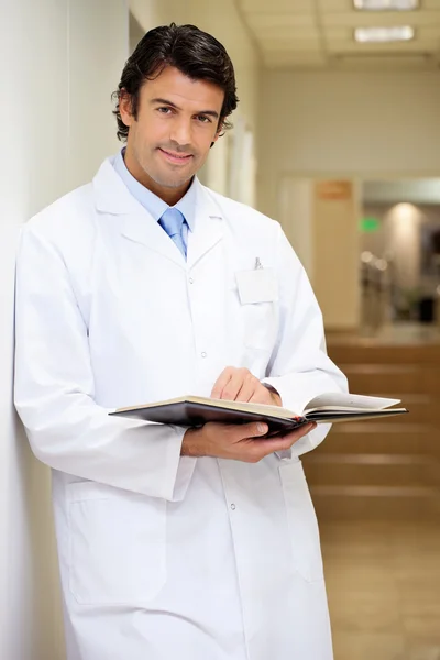 Mid Adult Doctor Holding Book