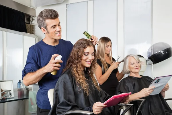 Hairdressers Setting Up Client\'s Hair In Salon