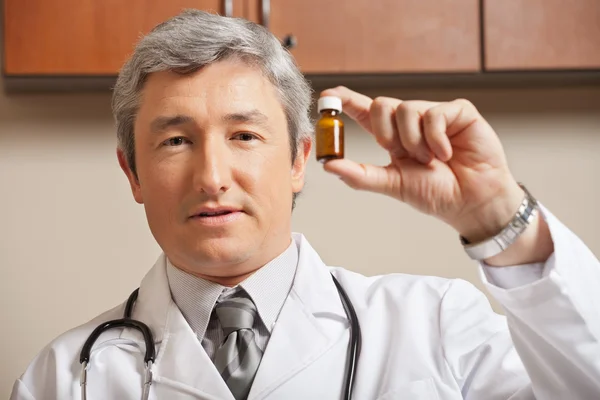 Physician Holding Medicine Bottle