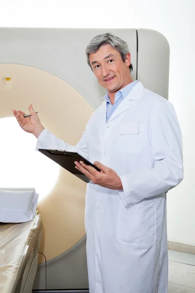 Doctor Presenting The CT Scan Machine