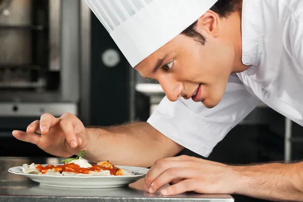 Male Chef Garnishing Dish