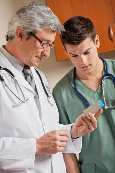 Medical Professionals Looking At Medicine Box