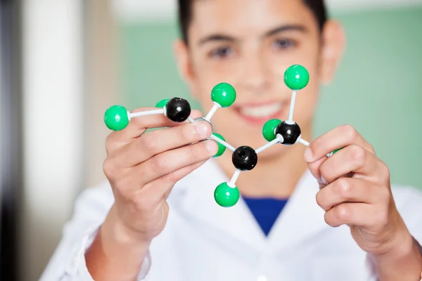 Schoolboy Examining Molecular Structure In Lab