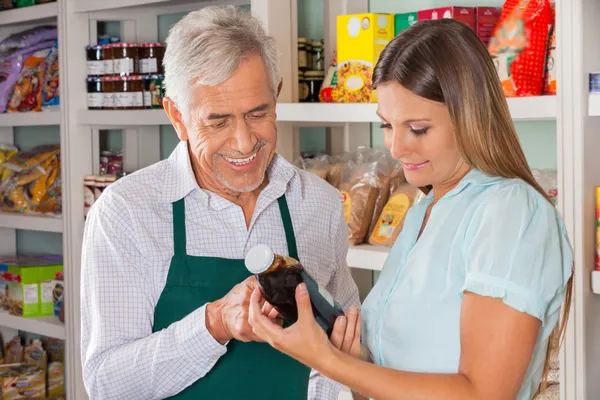 Male Owner Assisting Customer In Choosing Product