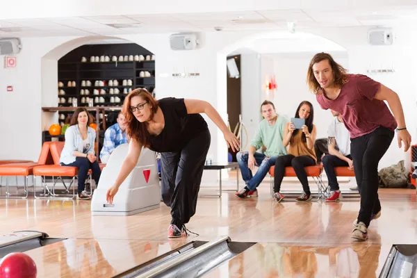 Man And Woman Playing in Bowling Alley