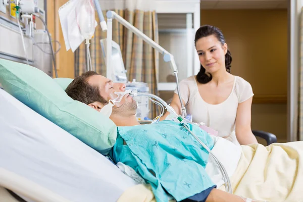 Woman Looking At Man In Hospital
