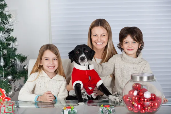 Happy Family With Pet Dog During Christmas