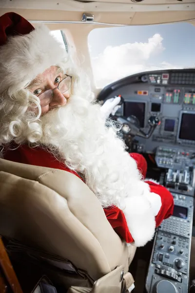 Man In Santa Costume Sitting In Private Jet\'s Cockpit