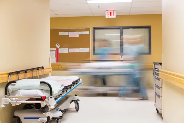 Nurses Walking In Hospital Corridor