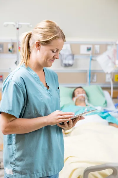 Nurse Using Digital Tablet In Hospital