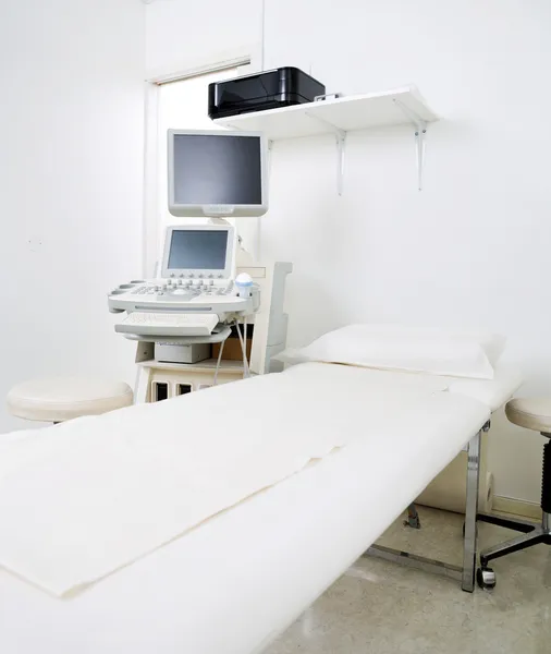 Examination Room With Bed And Ultrasound Machine