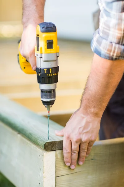 Carpenter\'s Hands Using Drill On Wood