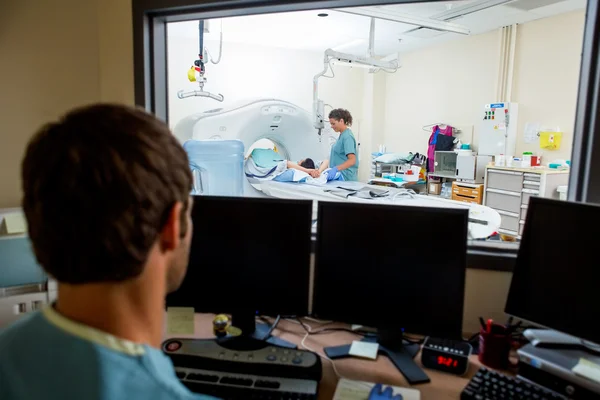 Radiologist Working In CT Scan Lab