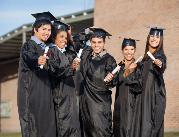 Graduate Students Holding Certificates On University Campus