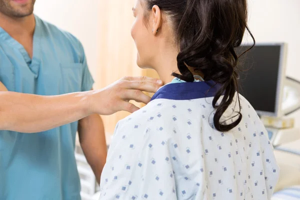 Nurse Examining Patient\'s Neck Before Ultrasound Test