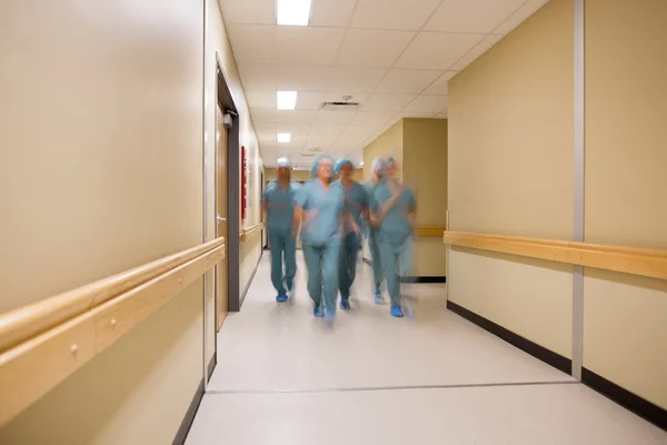 Multiethnic Medical Team Walking In Hospital Corridor
