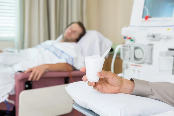 Cancer Patient Holding Glass Of Crushed Ice