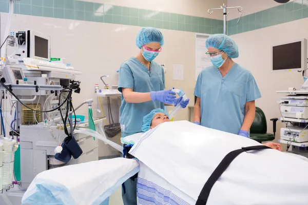 Nurse Adjusting Oxygen Mask On Patient
