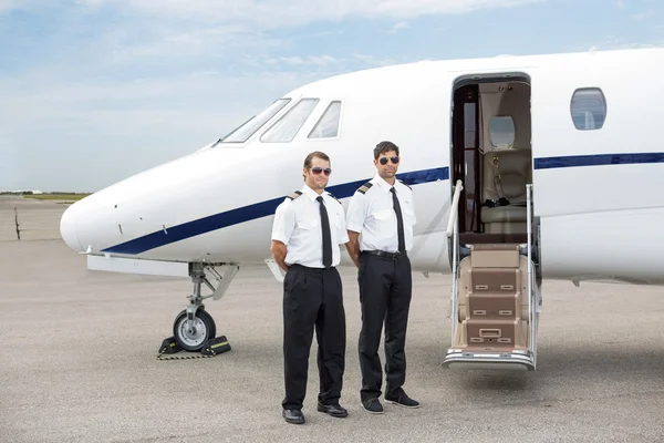 Pilots Standing In Front Of Private Jet
