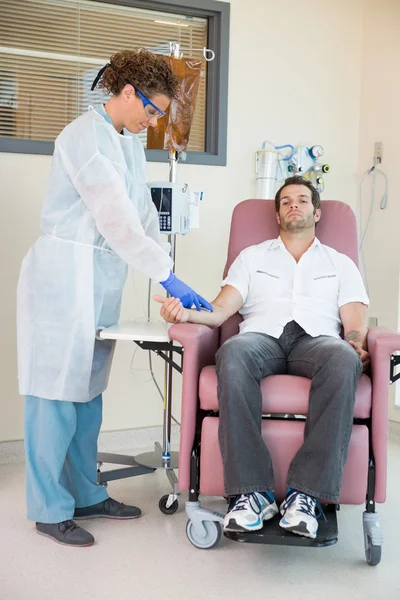 Nurse Injecting Cancer Patient During Intravenous Treatment In H